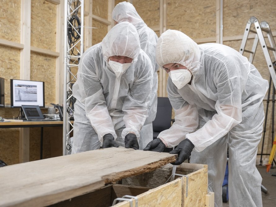 Arbeitsimpression von der Abnahme des Holzdeckels des innenstehenden Sarges. © Landesamt für Denkmalpflege und Archäologie Sachsen-Anhalt, Michel Klehm.